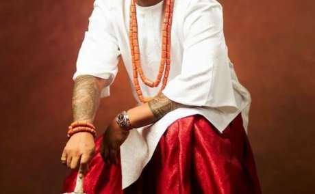 Tradition in Motion: White Top, Red Wrapper, Cap & Fan for the Igbo Groom